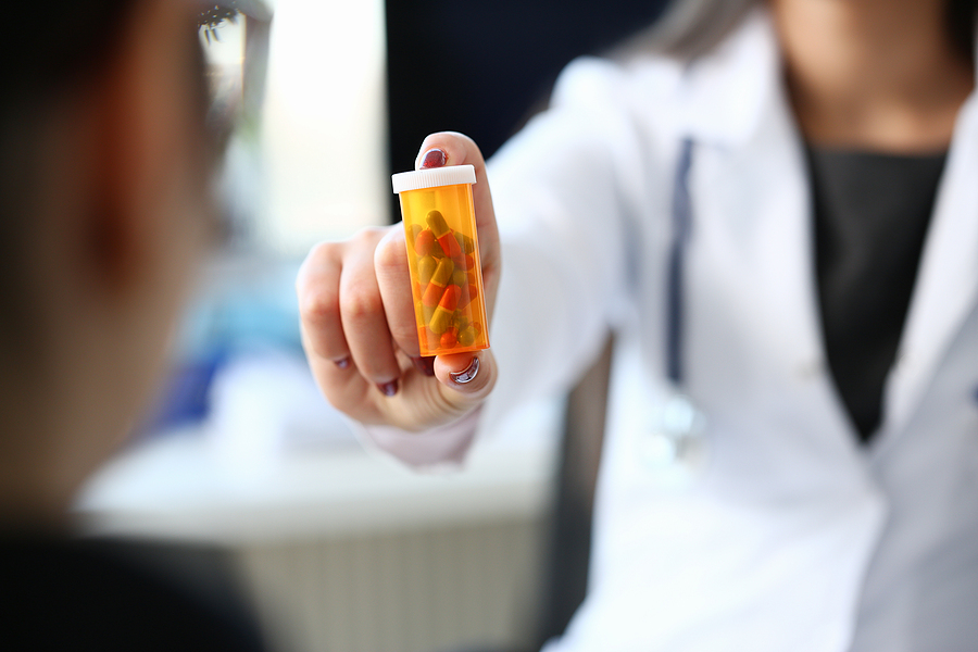 pharmacist with capsules