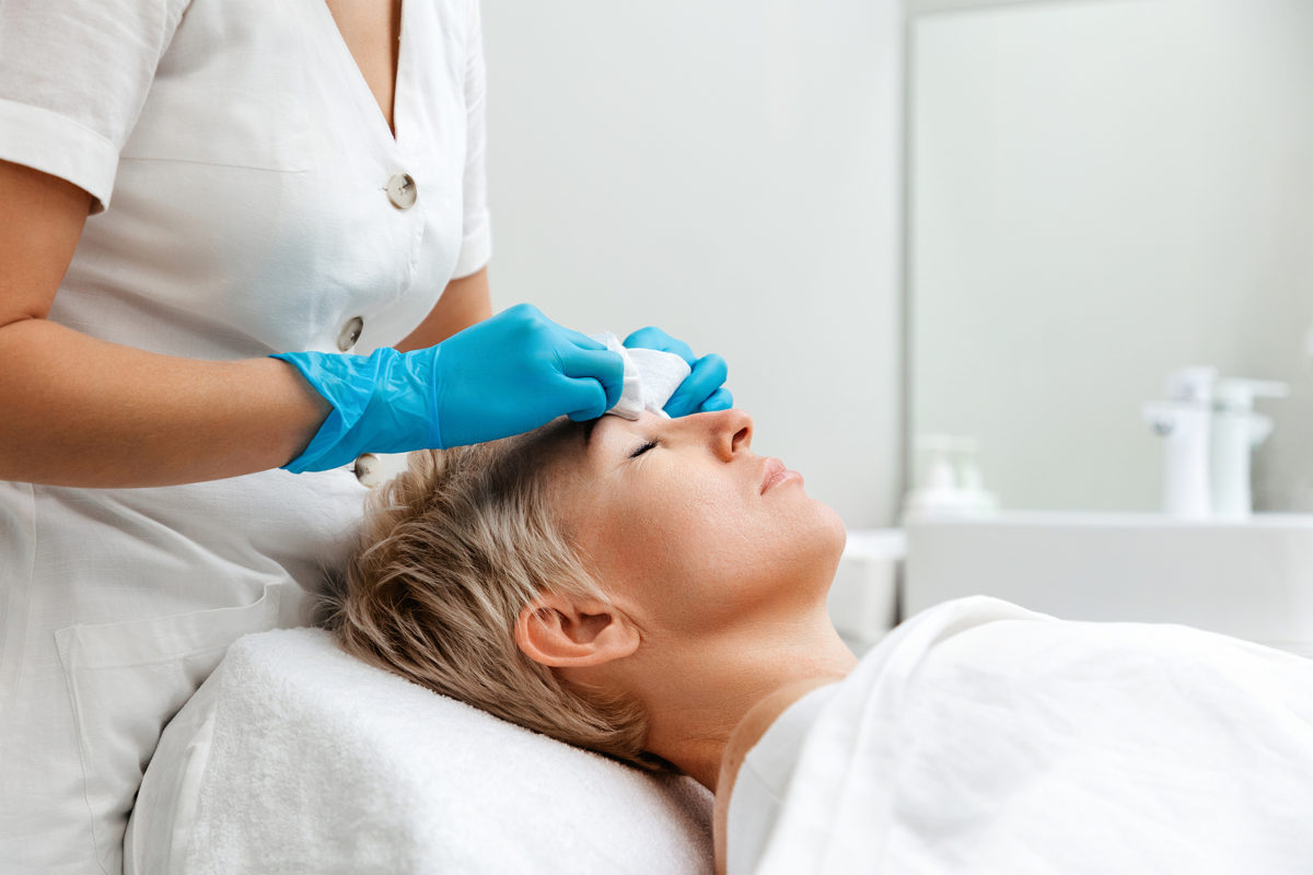 woman receiving an aesthetic treatment after having blt cream applied